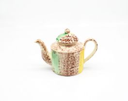 A small cylindrical Whieldon style teapot and cover, sponge decorated in brown, yellow and green