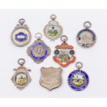 A collection of seven assorted silver hallmarked sporting fobs, to include: football, cycling,