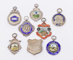 A collection of seven assorted silver hallmarked sporting fobs, to include: football, cycling,