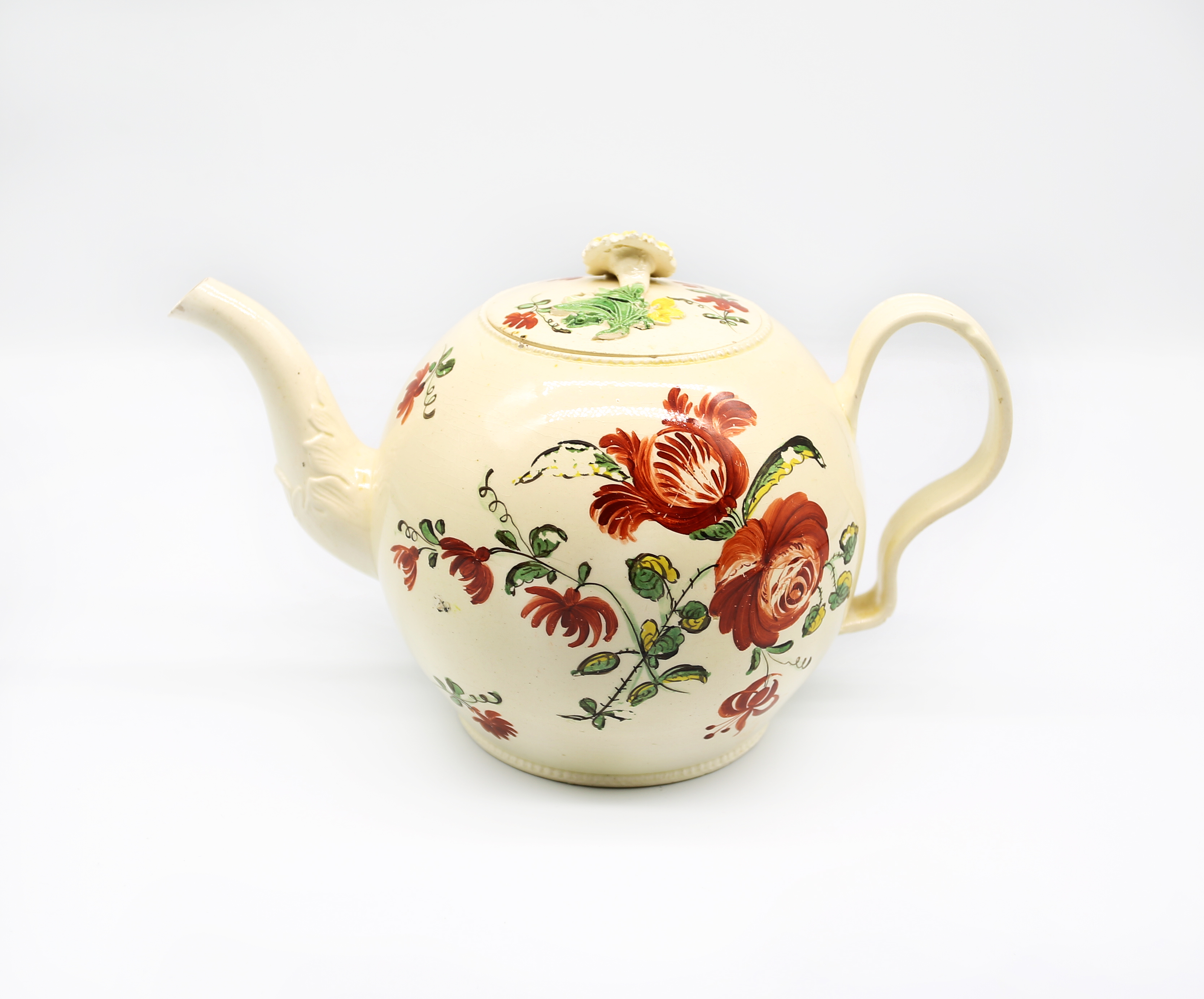 A Staffordshire William Greatbatch /Leeds creamware globular teapot and cover, painted with