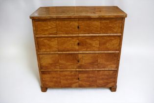 A Biedermeier four-drawer chest in birch veneer on pine frame, complete with key