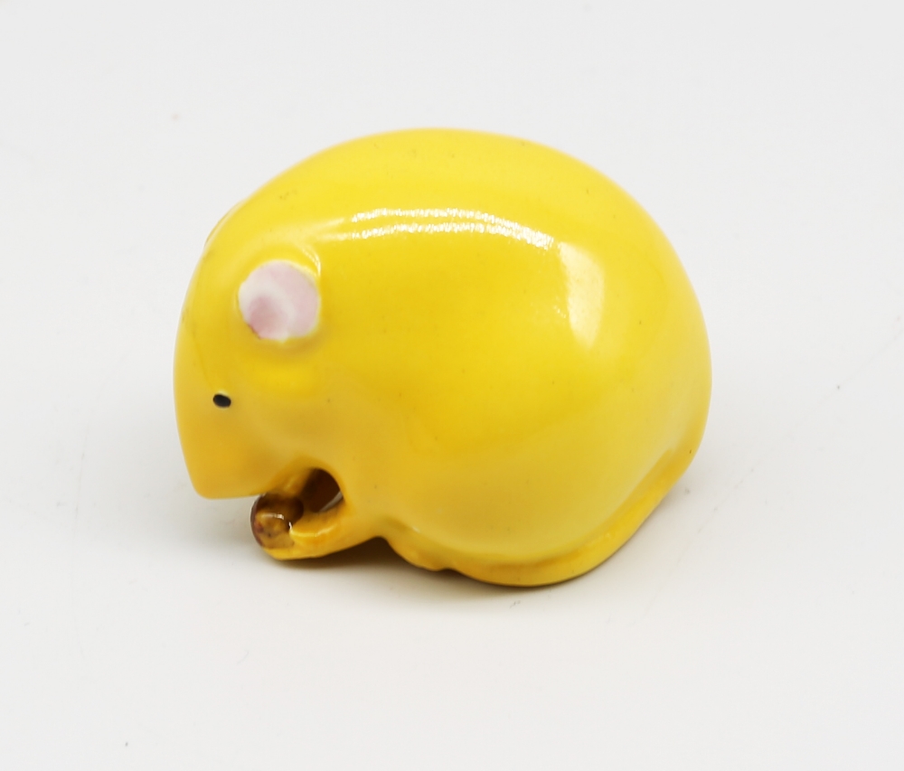 A Royal Worcester netsuke modelled as a mouse with nut in hands, yellow colourway, early to mid 20th