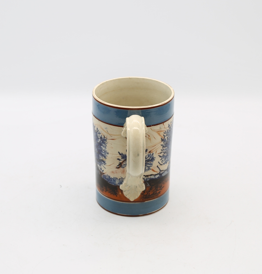 A mocha cylindrical mug, with blue feathered blue trees and a tan and black landscape and wide - Image 4 of 6