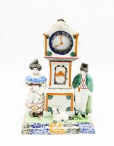 A Prattware watch stand and watch.  Flanked by a man and a woman and a dog. Complete with original