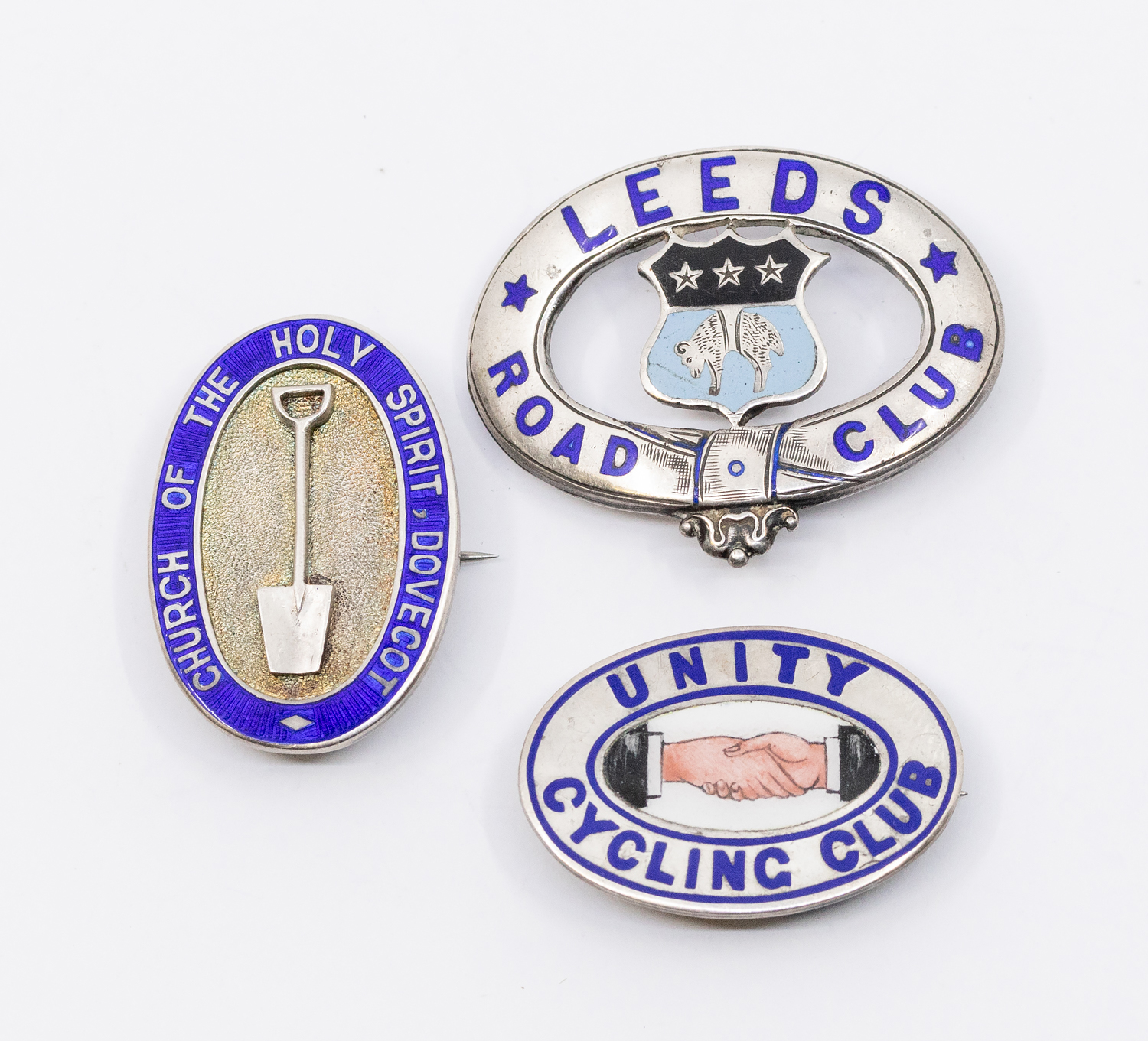 Three 20th century silver and enamel badges to include; a Unity Cycling Club oval pin badge with