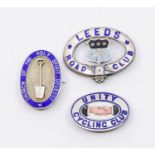 Three 20th century silver and enamel badges to include; a Unity Cycling Club oval pin badge with