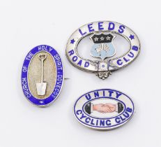 Three 20th century silver and enamel badges to include; a Unity Cycling Club oval pin badge with