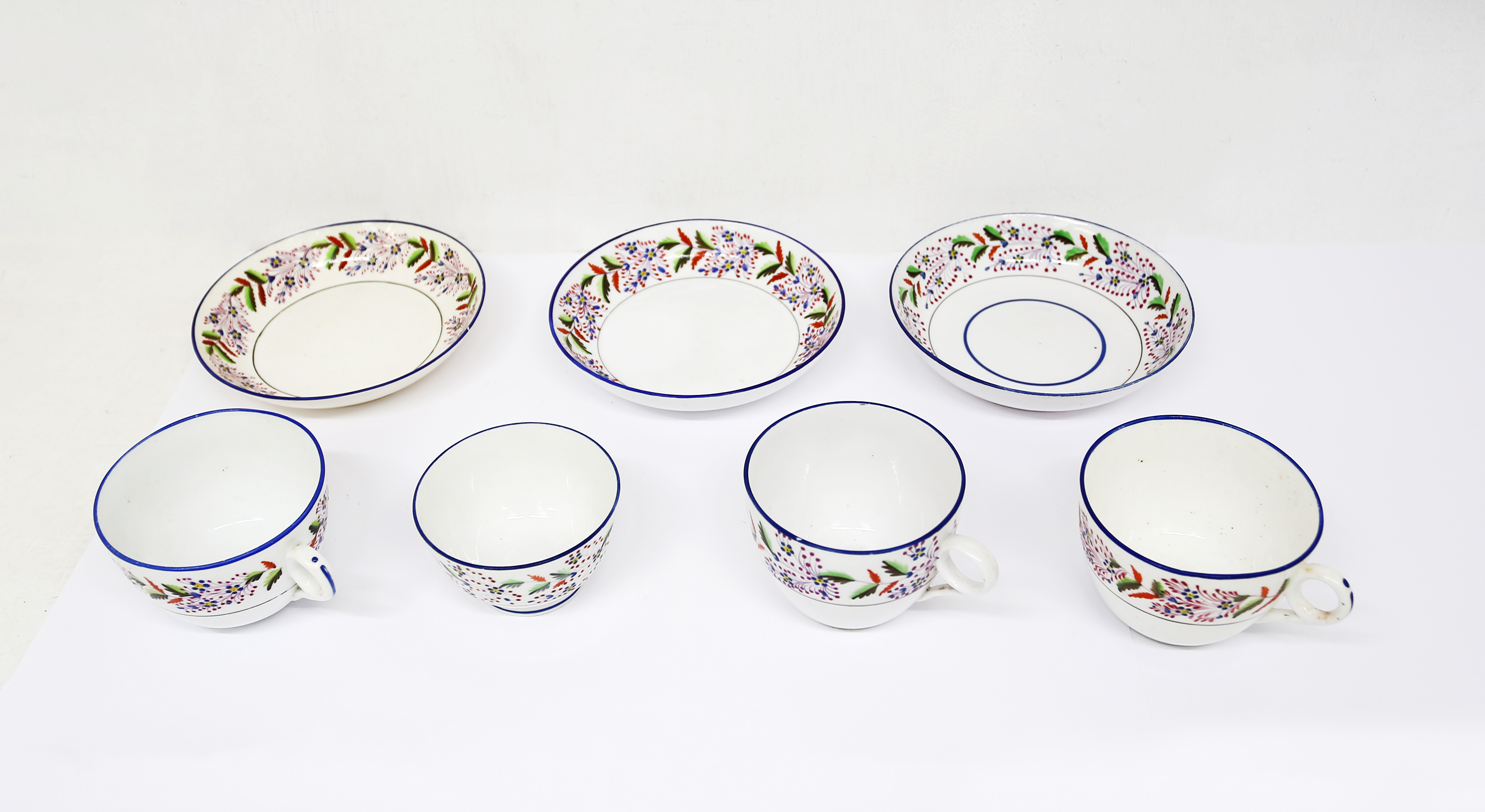 Small collection of Staffordshire pearlware cups and saucers and a tea bowl, decorated with bands of