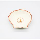 A Wedgwood creamware shell dish, with an orange border and a central reserve with a peacock.