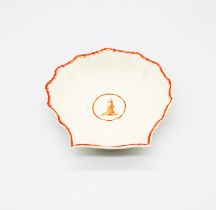 A Wedgwood creamware shell dish, with an orange border and a central reserve with a peacock.