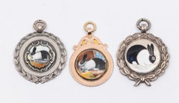 Three early to mid 20th century silver or gold and enamel fob medals, all with enamelled rabbit