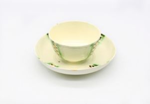 A creamware tea bowl and saucer decorated in copper manganese and yellow.  Circa 1770. Size. TB. 8cm