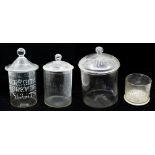 A collection of early 20th Century glass advertising jars, four in all, three with lids, Meredith