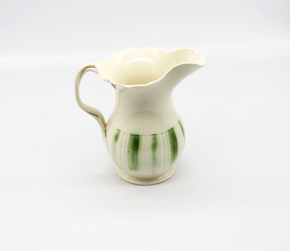 A Leeds creamware jug, with a flared scalloped rim and spout with a crossed strap handle, - Image 3 of 9