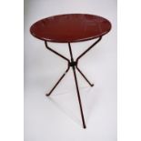 A red-painted circular, metal, folding table by Zanotta of Italy