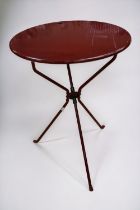 A red-painted circular, metal, folding table by Zanotta of Italy