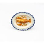 A pearlware ‘Toy’ oval platter with a lobster moulded to the centre with a blue feathered border.