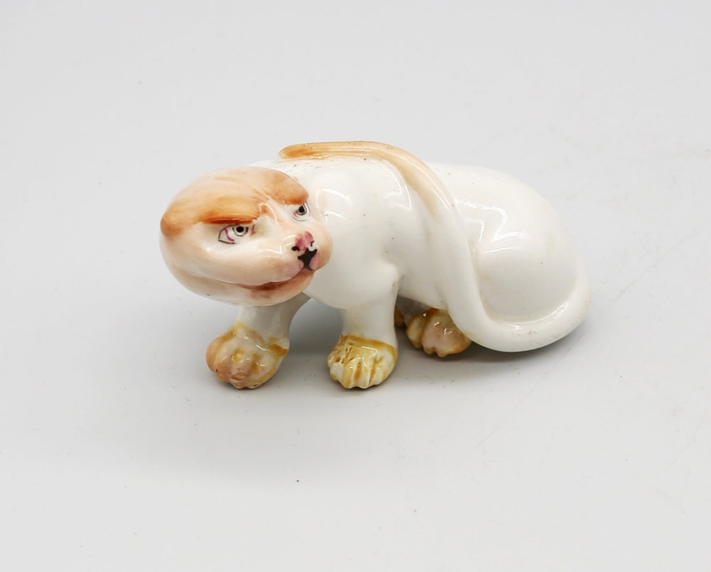 A Royal Worcester netsuke modelled as a Cheetah, early 20th century, painted details to white