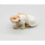 A Royal Worcester netsuke modelled as a Cheetah, early 20th century, painted details to white