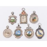 A collection of seven assorted silver hallmarked sporting fobs, to include: Tug of War, boxing,