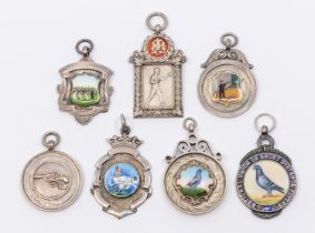 A collection of seven assorted silver hallmarked sporting fobs, to include: Tug of War, boxing,