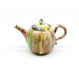 A small globular Whieldon style teapot and matched cover.  Decorated in green, brown and yellow