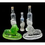 Three French 19th Century barber bottles, glass hand holding bottle, clear and frosted along with