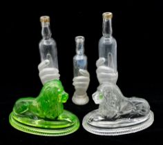 Three French 19th Century barber bottles, glass hand holding bottle, clear and frosted along with