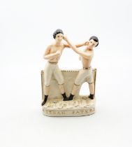 A reproduction Staffordshire white and gilt figure of Heenan and Sayers standing on an oval base.