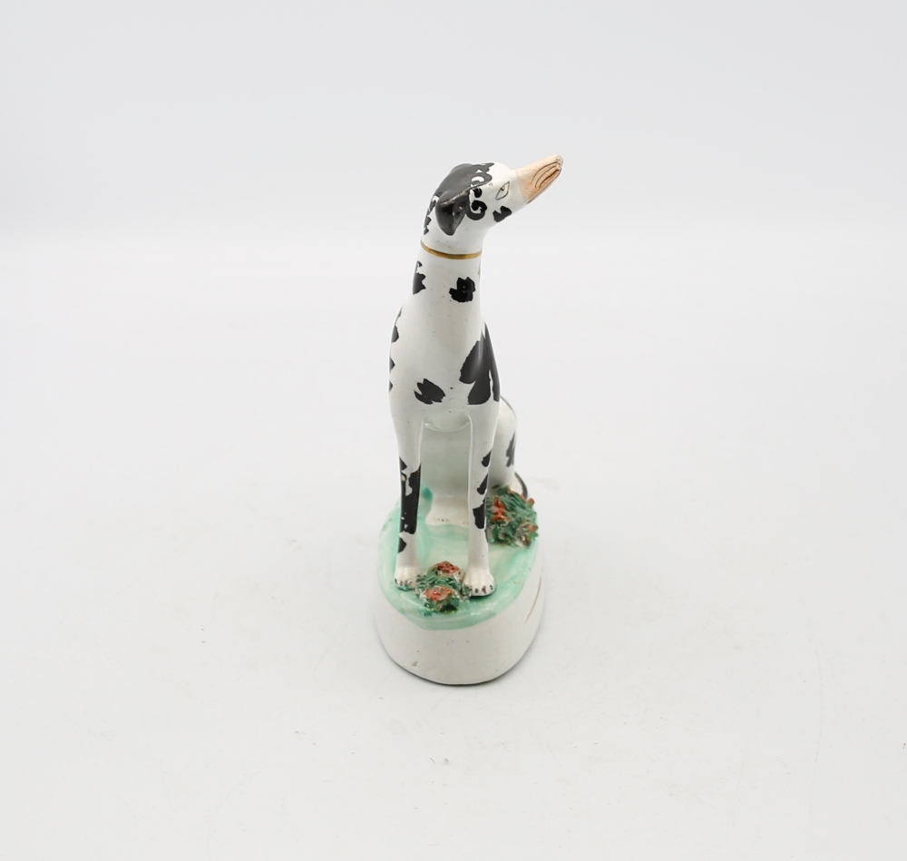 A Staffordshire potter model of a seated black and white Dalmatian on a green oval base.  Circa - Image 4 of 5