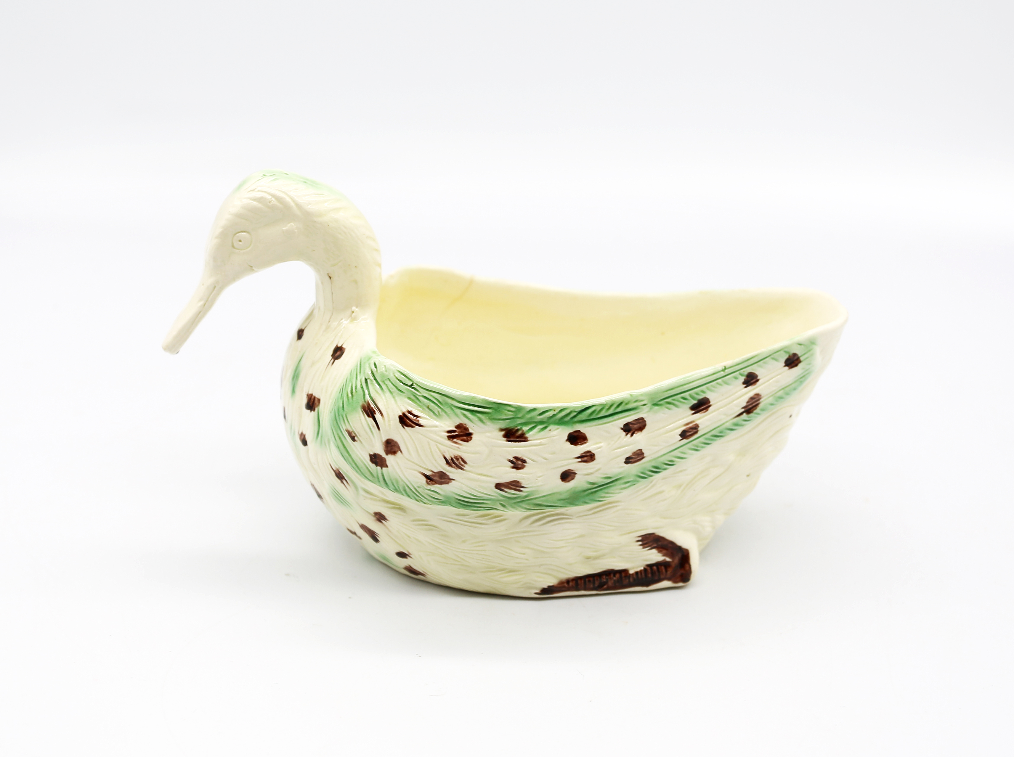 A Staffordshire creamware duck sauce boat decorated in green and brown.  Circa 1780-90 size 19cm x