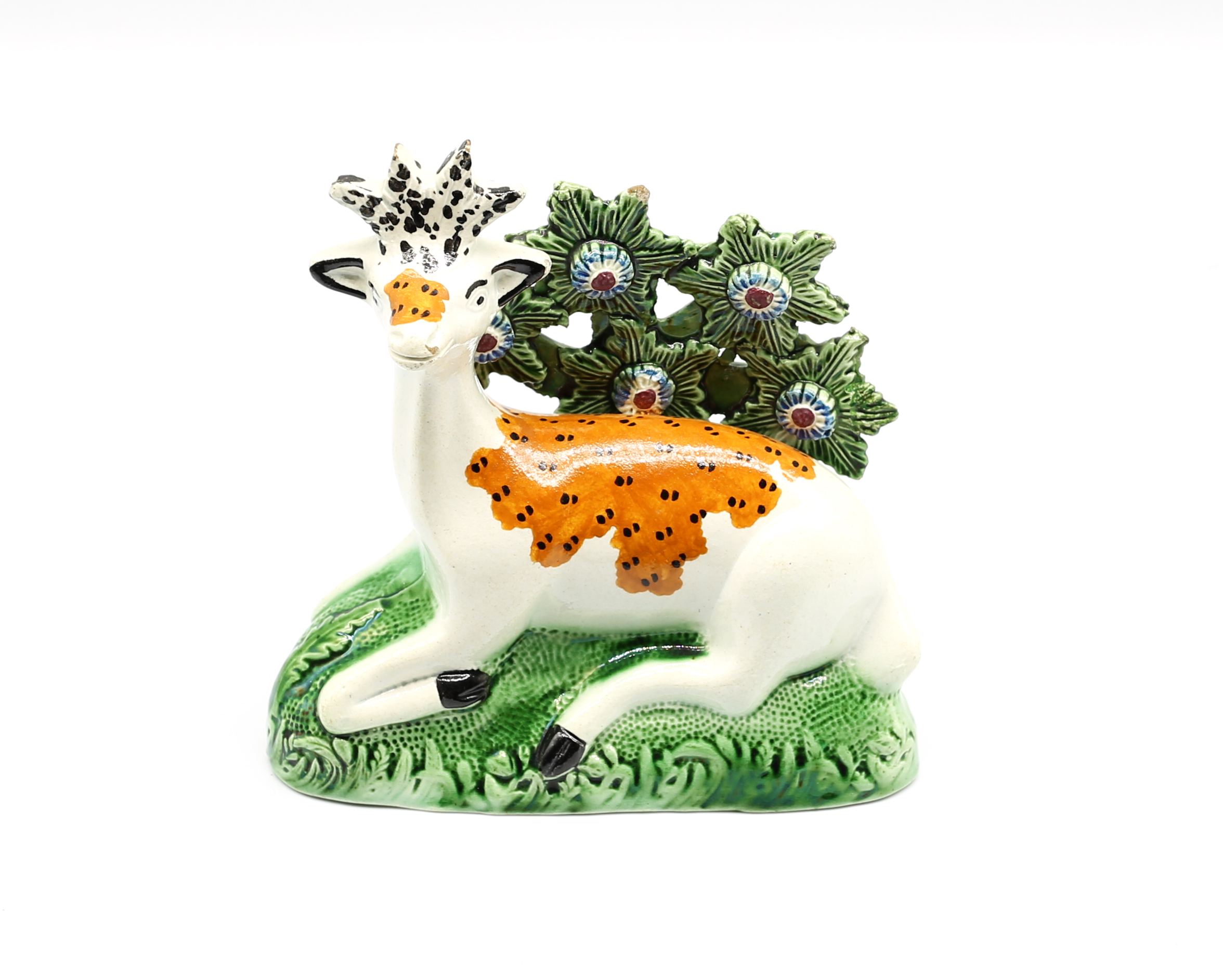A Staffordshire model of a stag at lodge before bocage on a green grassy mound Circa 1800  size 14.