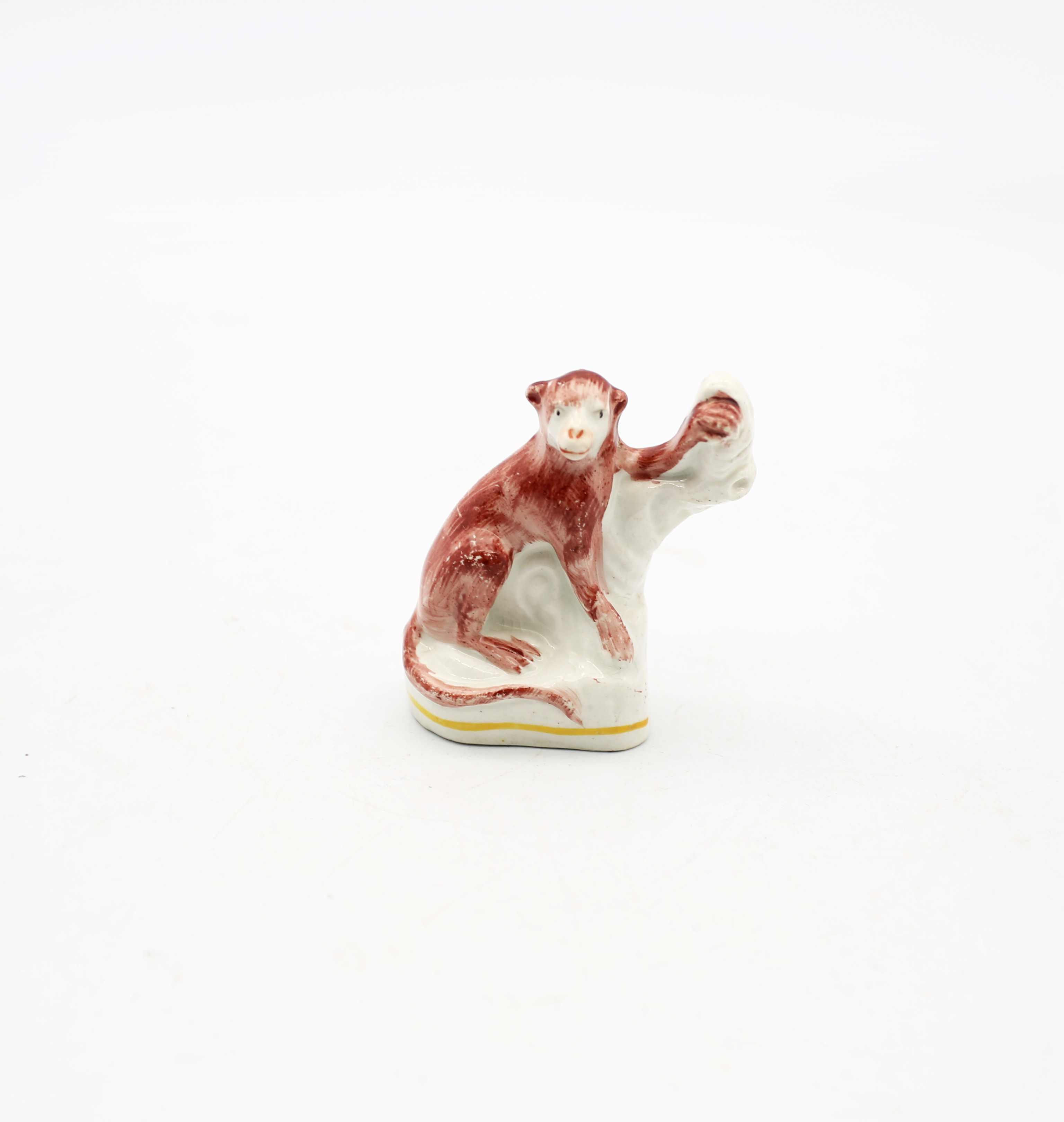 A rare Staffordshire pottery model of a Monkey perched on a tree stump.  Circa 1880. Size 8cm high.