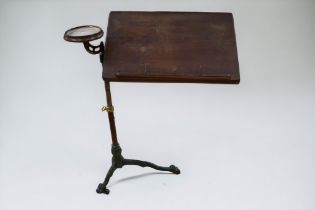 An adjustable reading stand on cast iron tripod feet