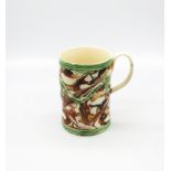 An 18th century creamware mug, commemorating Admiral Rodney. Decorated I surface agate style,