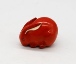 A Royal Worcester netsuke modelled as a Rabbit, orange colourway, circa 1913, with green stamp