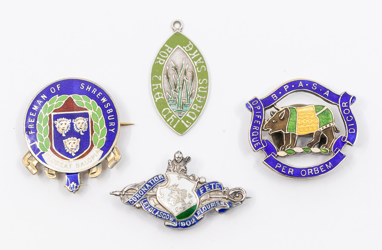 A small collection of four silver and enamel pin badges to include; a George V silver gilt '