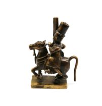 A 19th century Vizagapatam bronze figure of a Carabineer on horse, with flintlock carbine in hand,