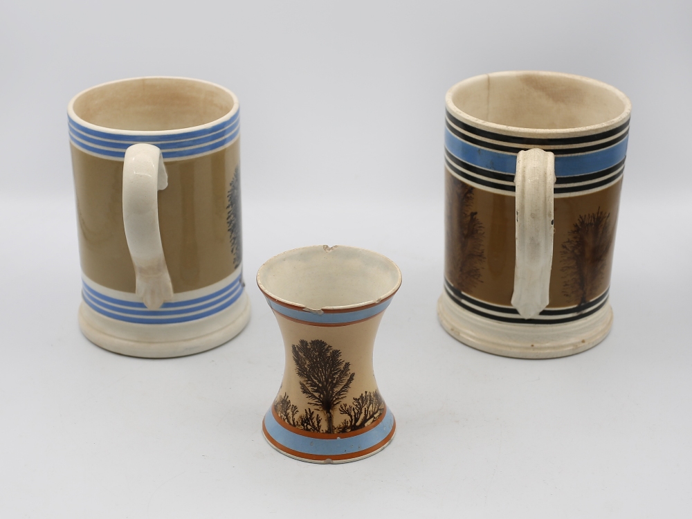A Mocha ware Quart sized mug, mid brown ground with feathered sepia trees, blue band and six black - Image 2 of 6