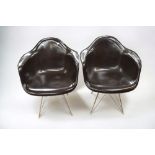 A pair of Herman Miller fibreglass and chrome easy chairs