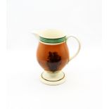 A creamware Mocha footed jug, dark terracotta with black feathered trees and green and brown
