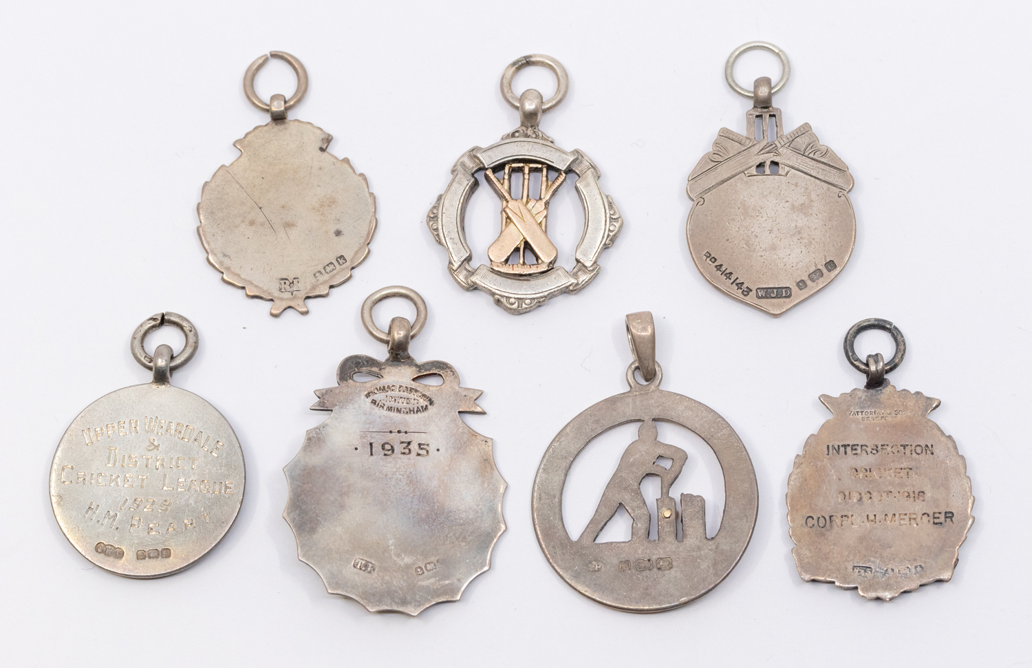 A collection of seven assorted silver hallmarked cricket fobs, to include: Palmers Green Junior - Image 2 of 2