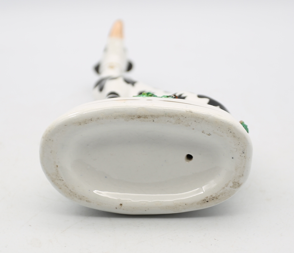 A Staffordshire potter model of a seated black and white Dalmatian on a green oval base.  Circa - Image 5 of 5