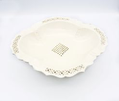 A creamware oval pedestal dish, with a fluted pierced rim and centre Circa 1800. Size 31x28cm