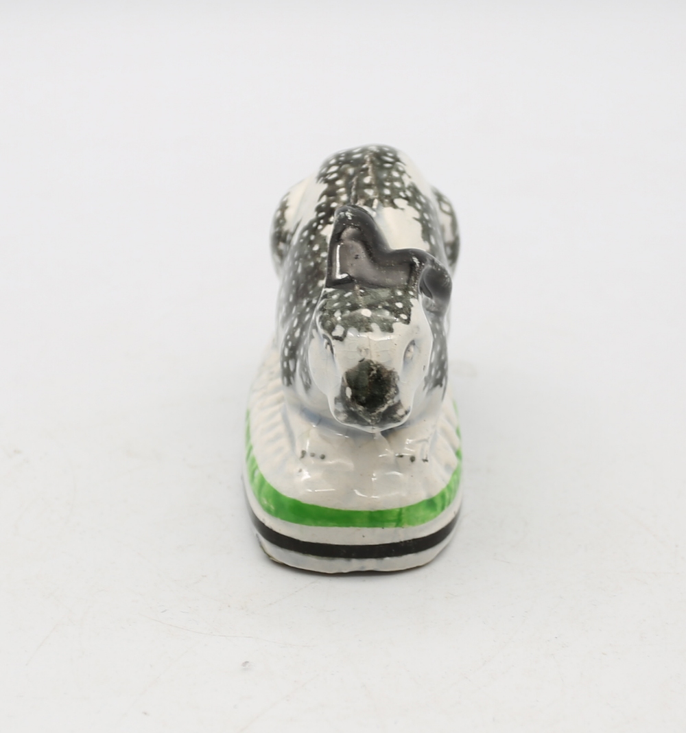 A Staffordshire pottery Rabbit crouched on an oval base, black sponged markings,  with green and - Image 2 of 5