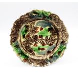 A Staffordshire Whieldon Plate, sponge decorated in greens and browns with a fluted relief