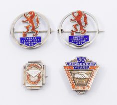 Two 20th century circular silver pin badges, both with central enamelled rampant lions and title "