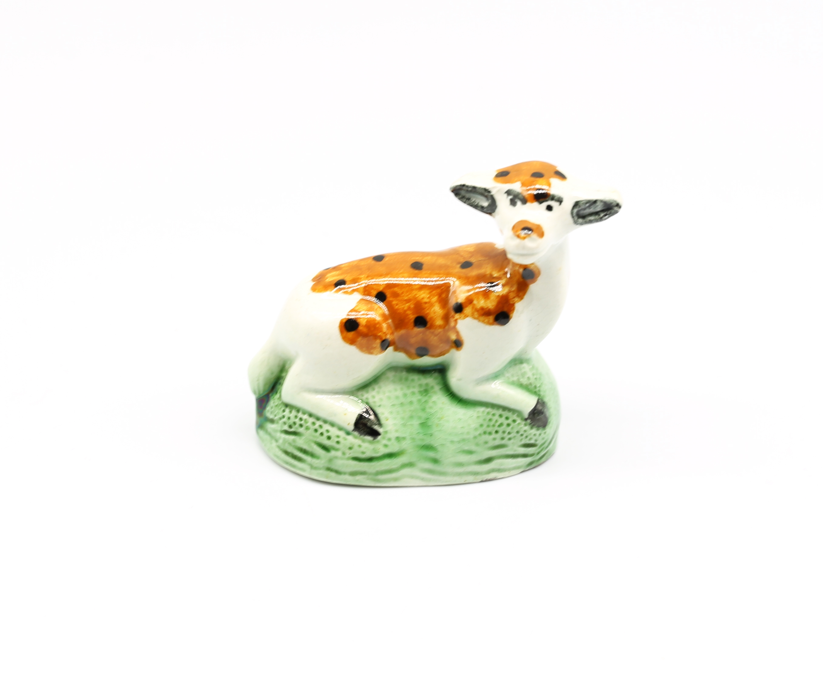 A small Yorkshire model of a recumbent Doe laying on a green grassy mound  Circa 1800. Size. 6cm
