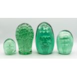 A collection of four Victorian 'End of Day' glass paperweights, all green glass with bubble effect