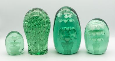A collection of four Victorian 'End of Day' glass paperweights, all green glass with bubble effect